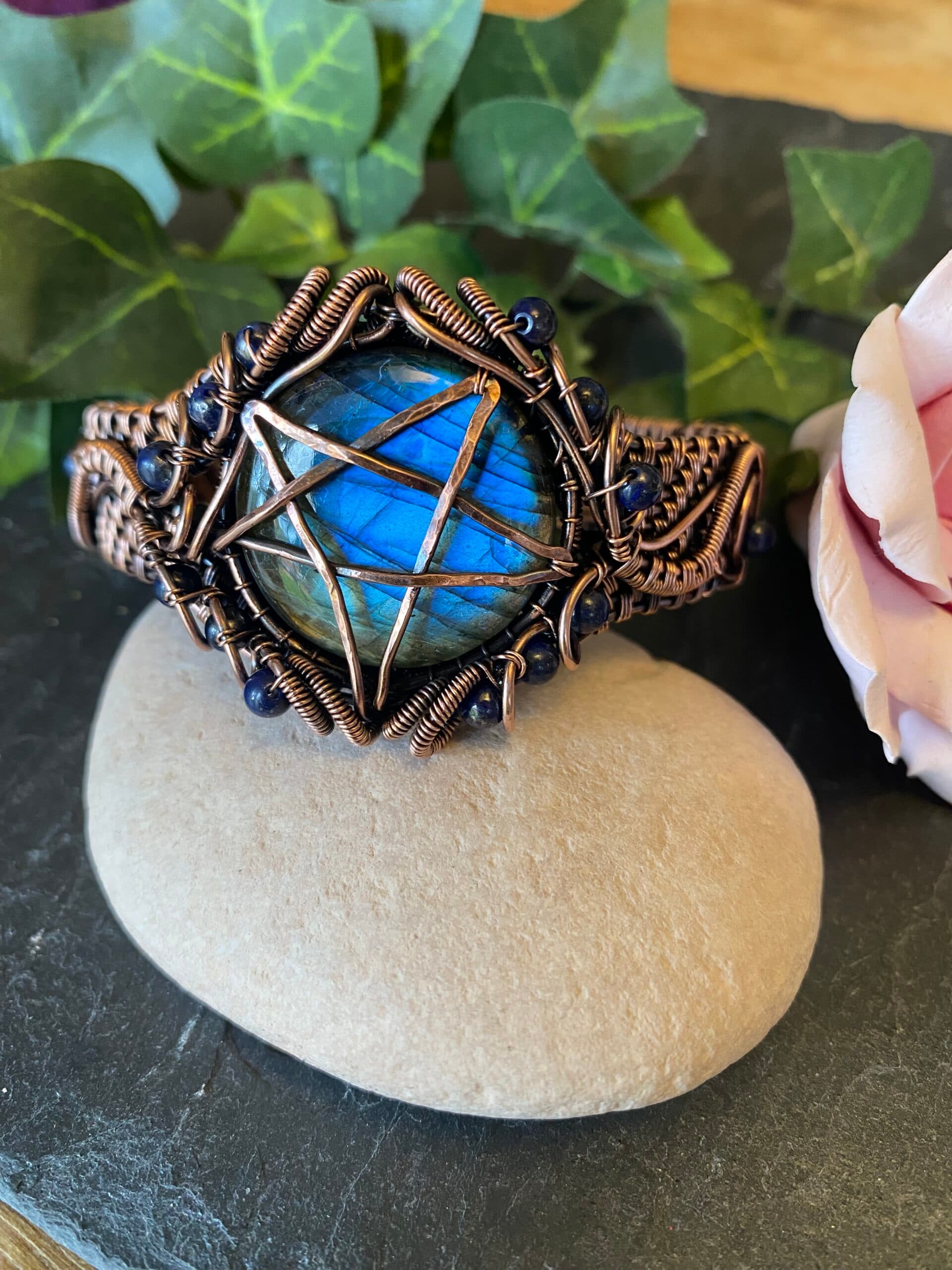 Handwoven copper pentagram cuff bracelet with hammered symbol and lapis lazuli beads Copper pentagram cuff bracelet showing woven wire detail and blue beads Handwoven copper cuff bracelet with antiqued pentagram and lapis accents