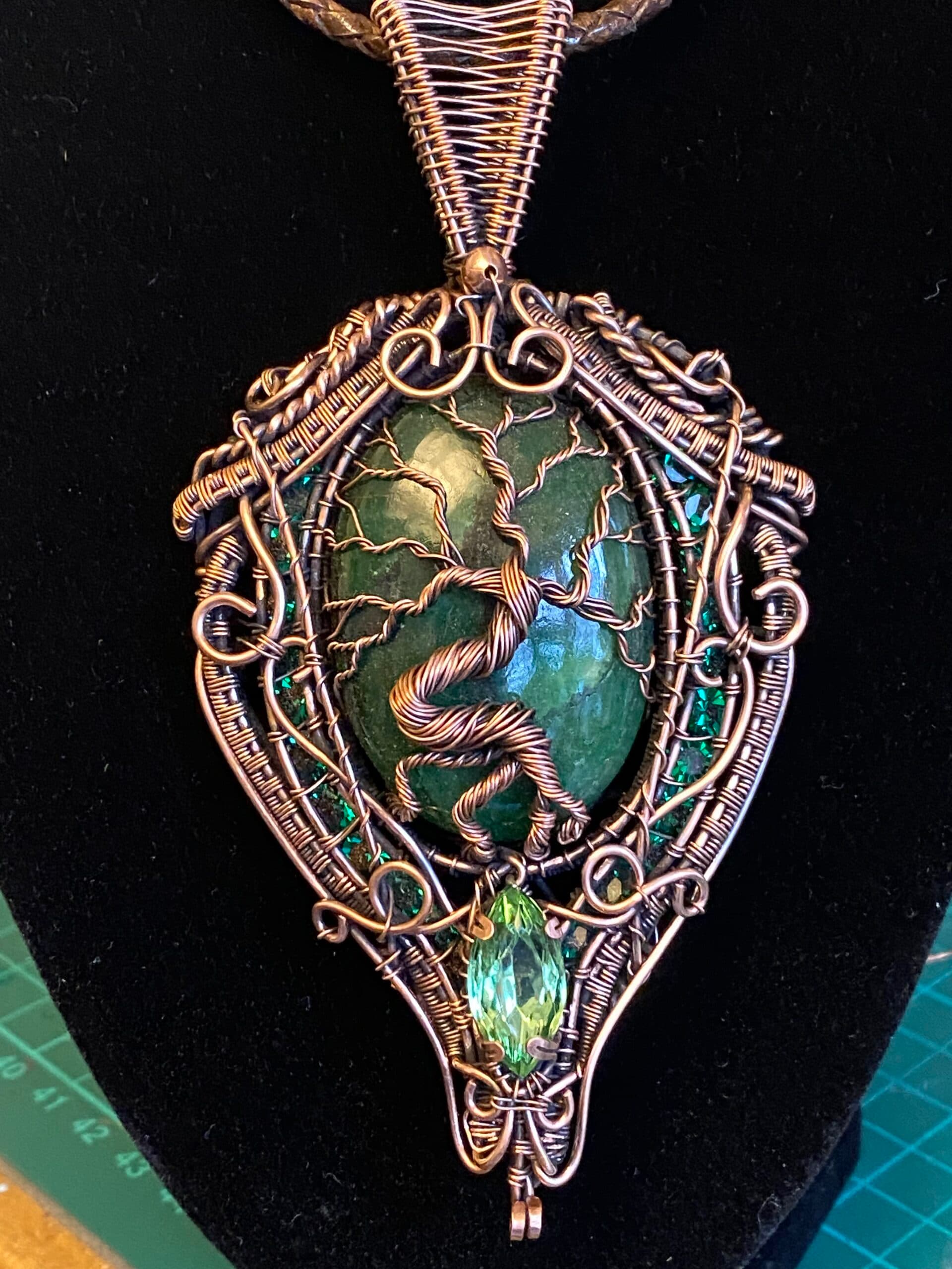Brazilian emerald copper wire wrapped necklace with Tree of Life design Oval Brazilian emerald pendant with channel set Swarovski crystals Copper wire emerald statement necklace with vintage Swarovski gem Handwoven copper wire emerald necklace detail