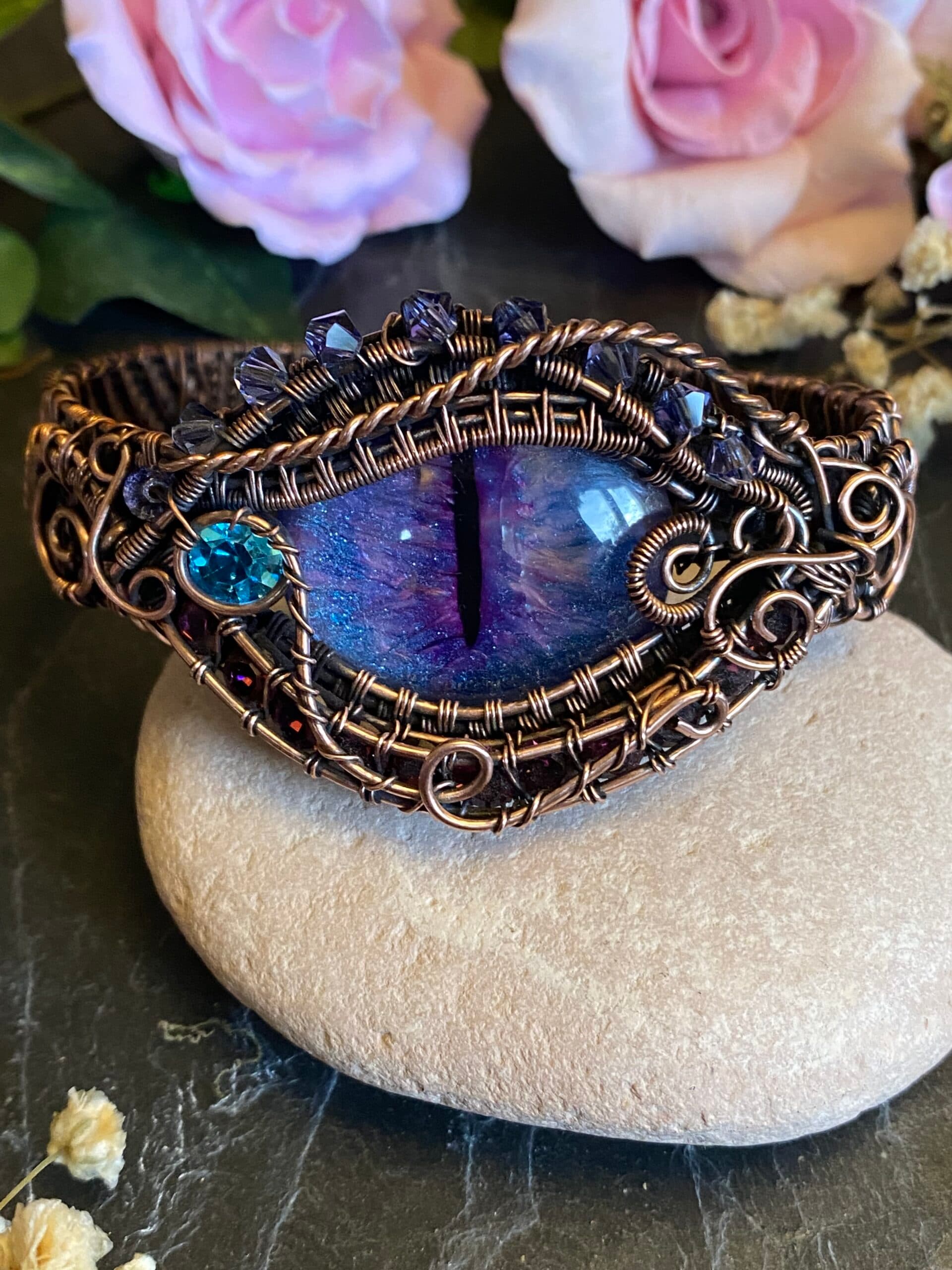 Handmade purple dragon eye copper cuff bracelet with blue and lilac hand-painted eye, Swarovski crystals and ornate wire weaving.
