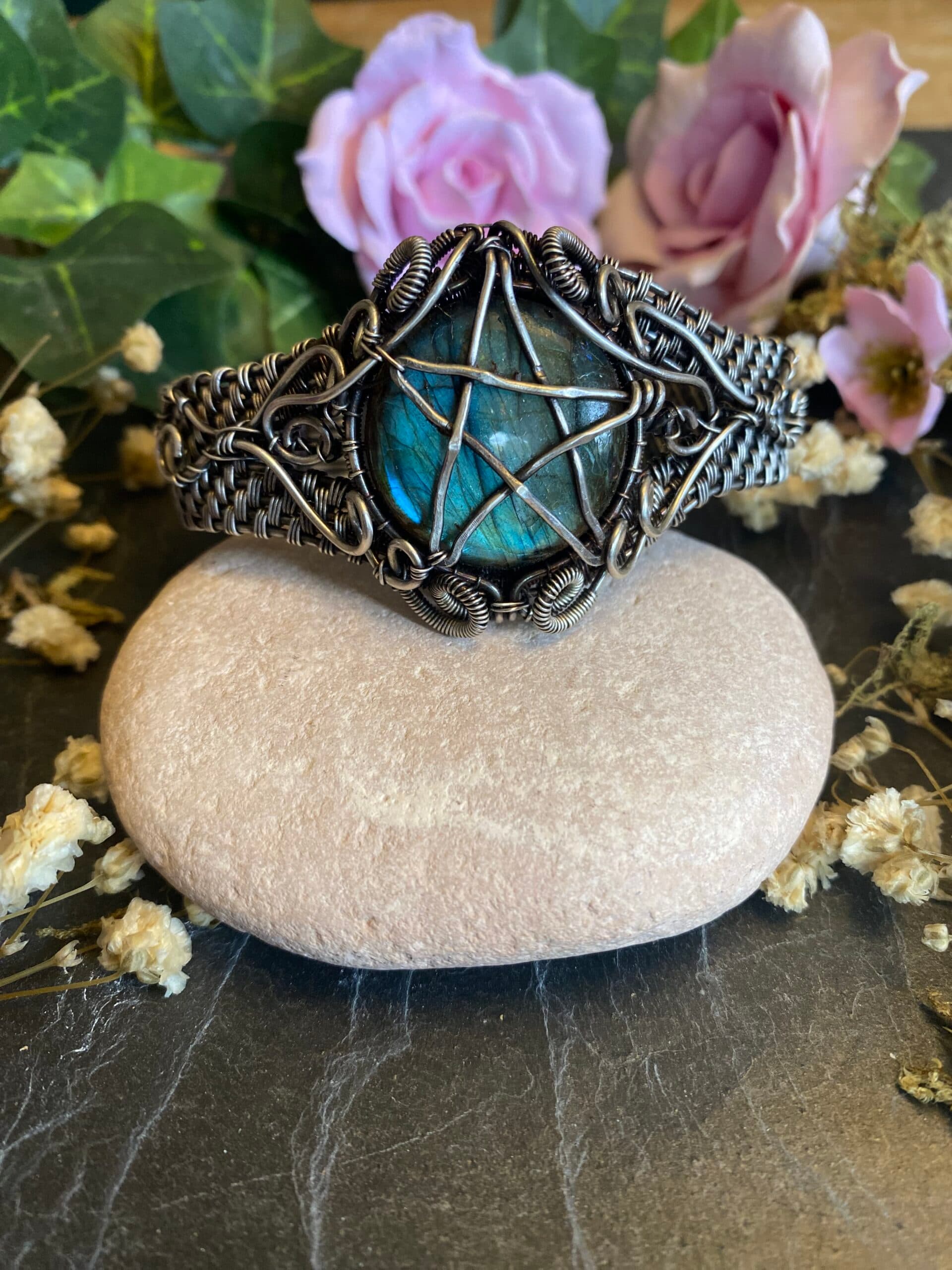 Handmade labradorite pentagram cuff bracelet with blue-green gemstone flash, silver filled wire weaving and ornate scrollwork.