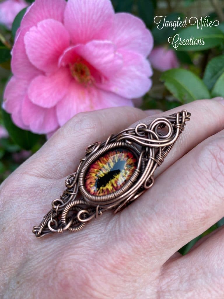 A handcrafted copper wire-wrapped dragon eye pendant