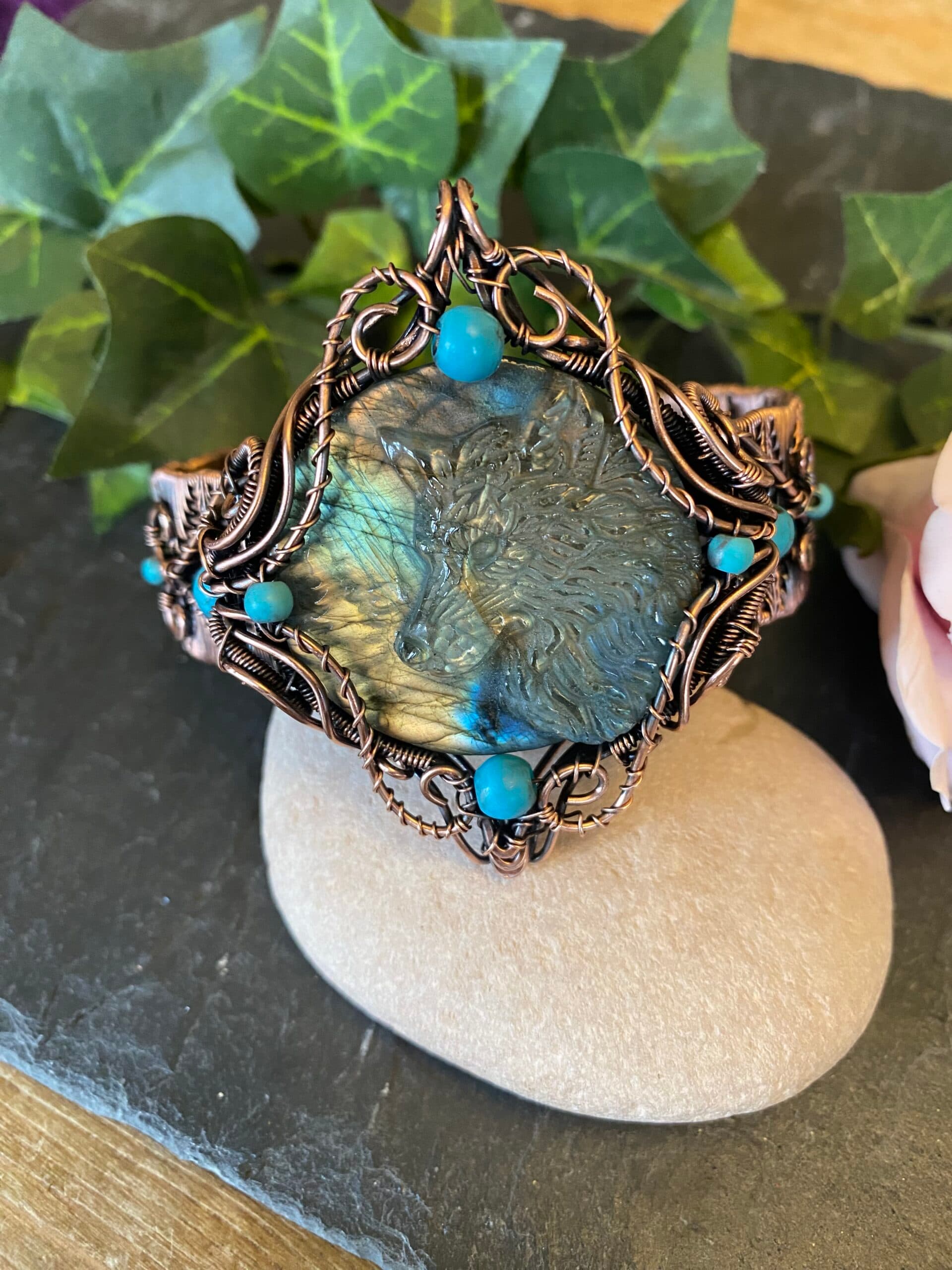 Handwoven copper wolf cuff bracelet with labradorite wolf head cabochon and turquoise beads Copper wolf cuff bracelet showing woven wire detail and antiqued finish Handwoven copper wolf bracelet with carved labradorite cabochon in blue and gold tones