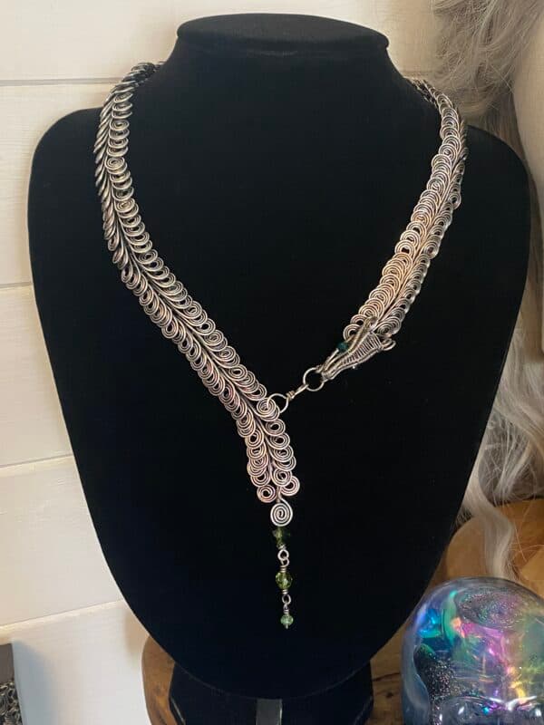 Handmade dragon scale silver plated necklace with layered wire links and green bead detail