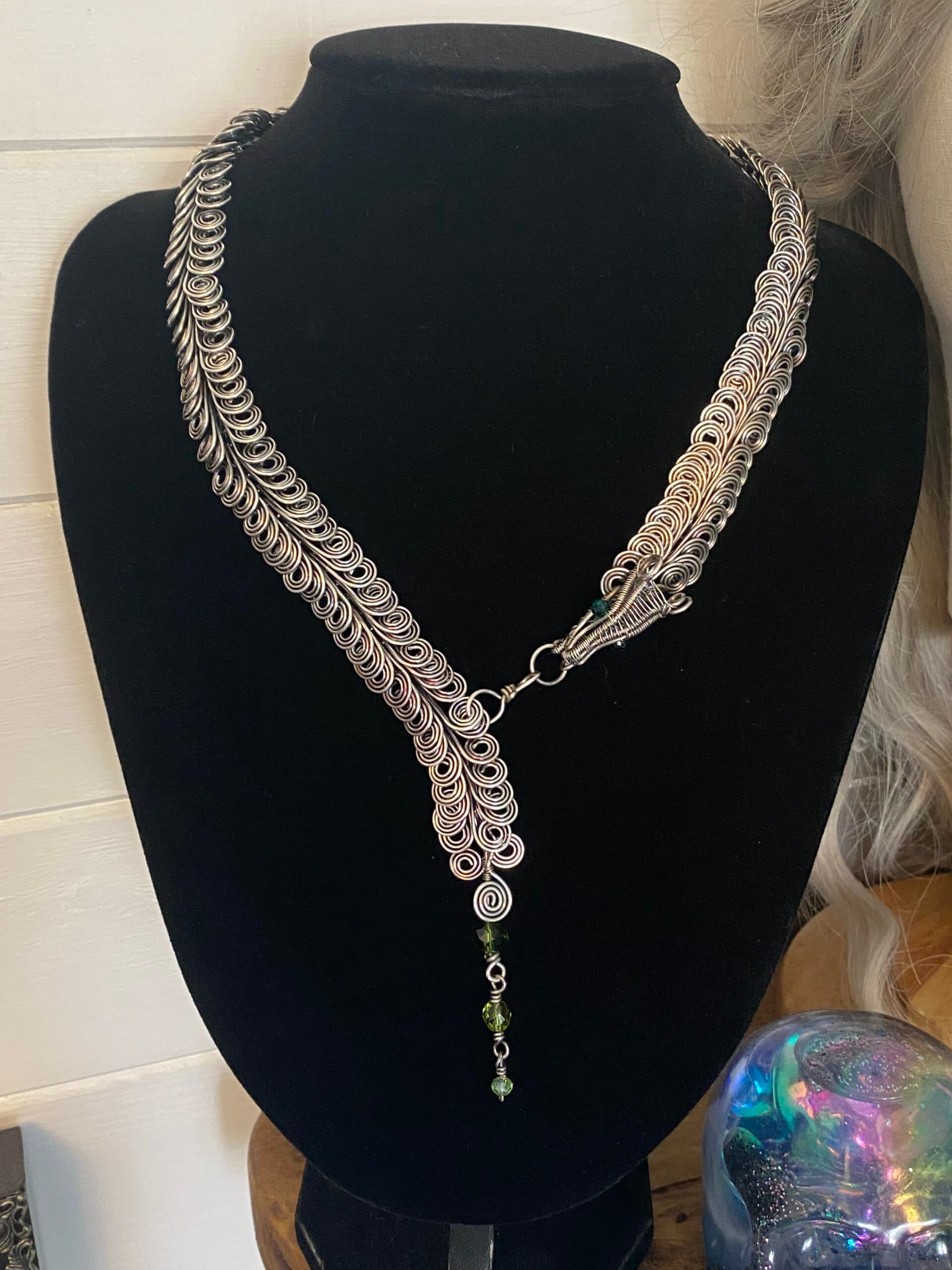 Handmade dragon scale silver plated necklace with layered wire links and green bead detail
