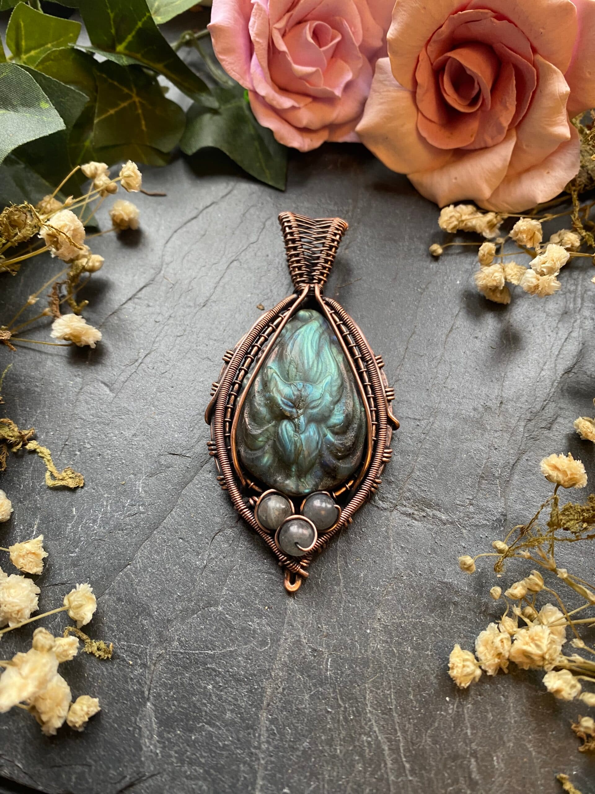 Handcrafted carved labradorite fox pendant wrapped in intricate copper wire with decorative scrollwork and woven bail, inspired by Japanese Kitsune folklore