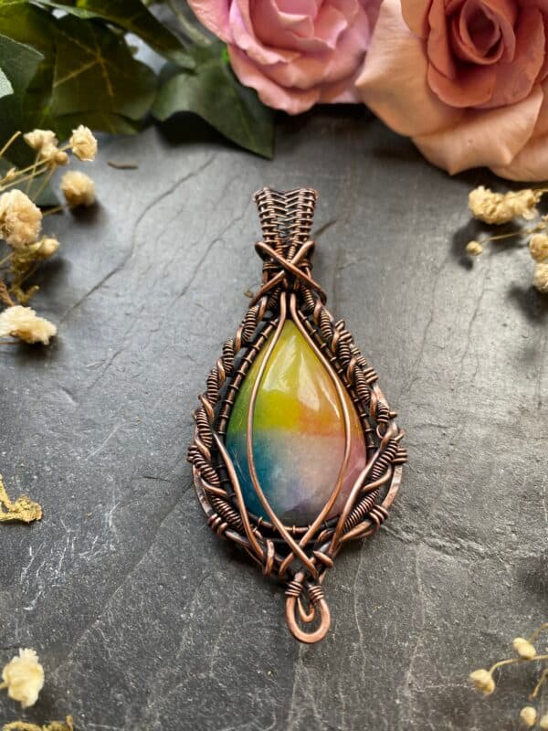 Handmade rainbow agate pendant featuring genuine dyed teardrop agate with yellow, green, blue and purple colours, wrapped in detailed copper wire.