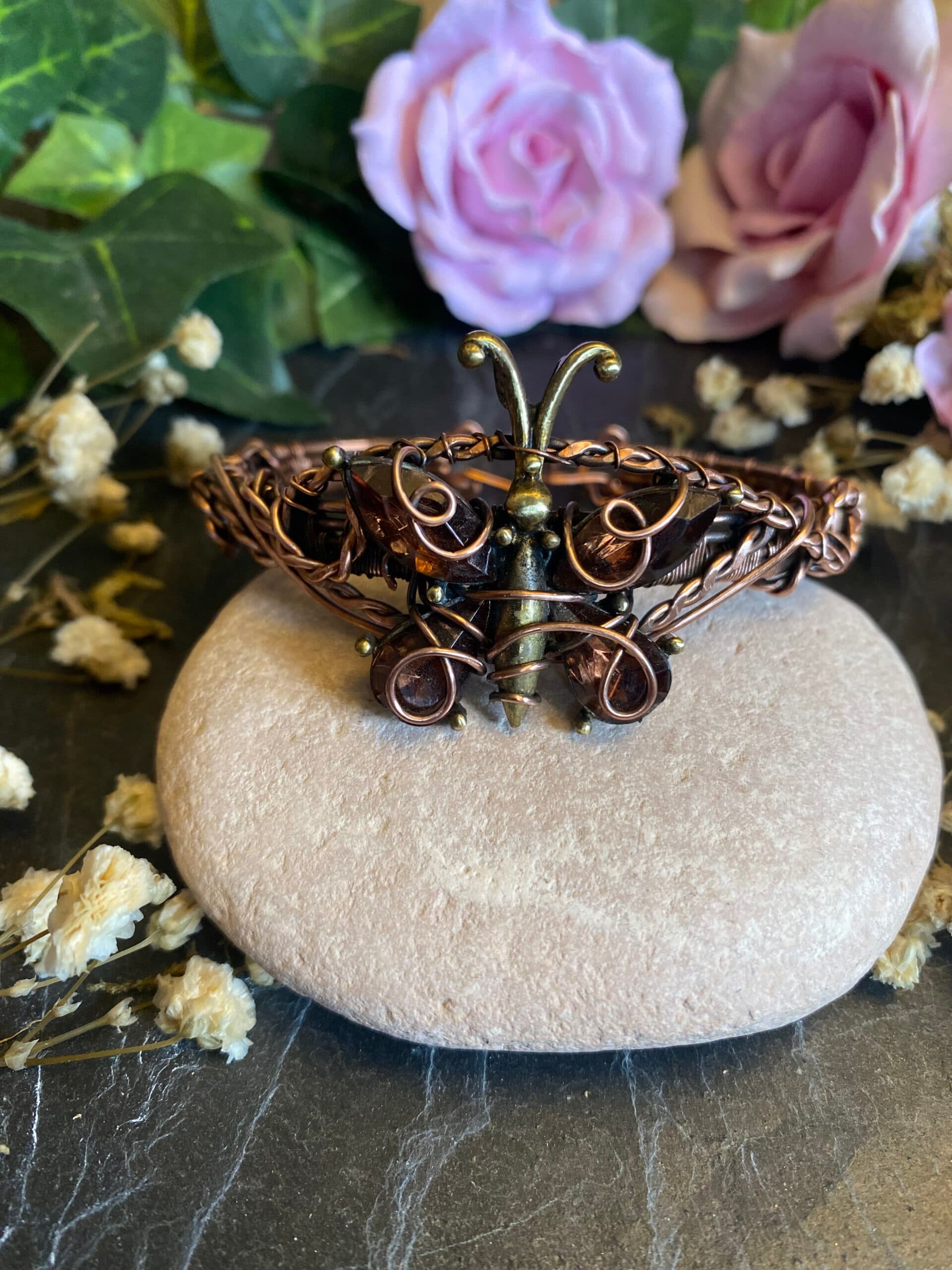 Delicate handmade copper butterfly cuff bracelet featuring a repurposed vintage brooch with smoky quartz gemstones and ornate wire scrollwork.