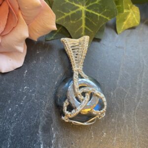 Handmade labradorite pendant with bright blue flash, wrapped in 10% silver filled wire in a Celtic knot design around a stainless steel core.