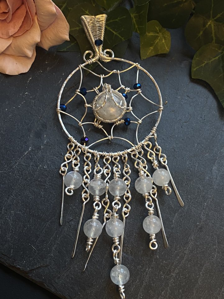 Handmade silver filled wire wrapped dreamcatcher pendant with rainbow moonstone cabochon, blue glass beads, and moonstone bead fringe.